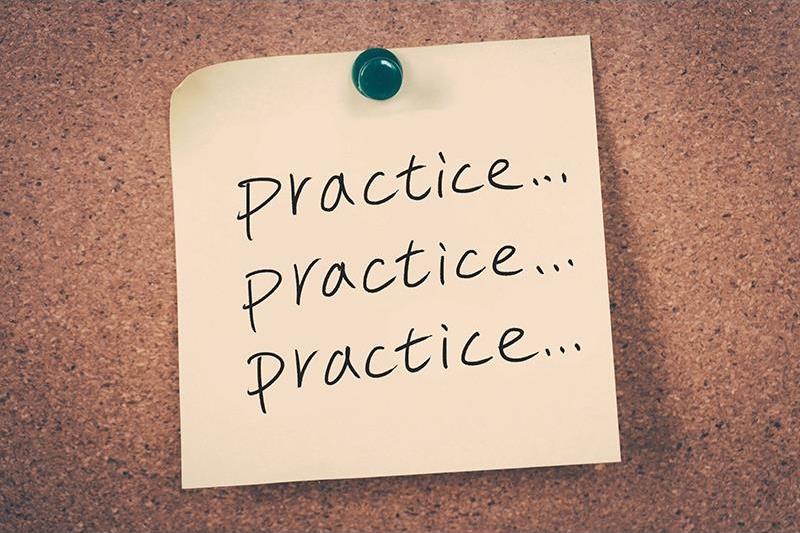 Sticky note pinned to a corkboard with the handwritten words "Practice... Practice... Practice..."